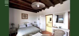 a bedroom with a bed and a television in a room at Villa élégante à Murs avec piscine privée in Murs