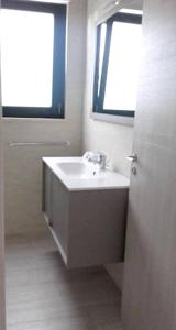 a bathroom with a sink and a window at Cosy Apartment in Carovigno, 40 sqm with Garden in Carovigno
