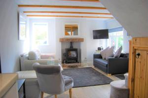a living room with a couch and a fireplace at Snowdrop Cottage nr Alton Towers & Peak District, Sleeps 4+2 in Cauldon