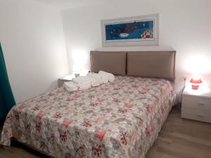 a bedroom with a bed with a quilt on it at Spacious villa with sea and mountain views in Alcamo in Alcamo +32 photos