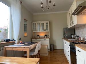 a kitchen with a table and a dining room at Hostel Czecha in Warsaw