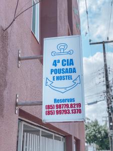 a sign on the side of a building at 4ª Cia Hostel e Pousada in Fortaleza