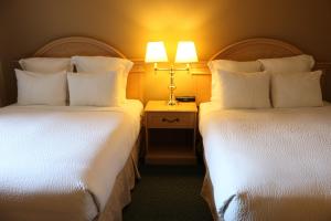 Postel nebo postele na pokoji v ubytování Nomad Hotel & Suites