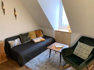 a living room with a couch and a chair at Villa Ammonit in Pottenstein