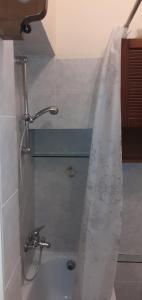 a shower in a bathroom with a shower curtain at Grandpa Mau in Lucca +56 photos