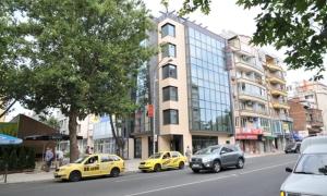 three yellow taxi cabs parked on a city street at Hotel Burgas Free University in Burgas City