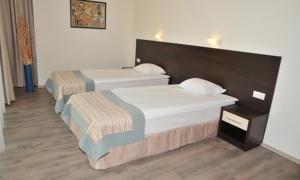 a room with two beds in a room at Hotel Burgas Free University in Burgas