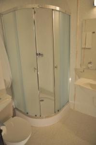 a bathroom with a shower with a toilet and a sink at Hotel Burgas Free University in Burgas