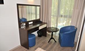 a room with a desk and a chair and a mirror at Hotel Burgas Free University in Burgas