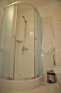 a bathroom with a shower and a toilet at Hotel Burgas Free University in Burgas