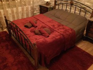 a bedroom with a bed with red sheets and pillows at The Love Holiday House in Tris Elies +47 photos