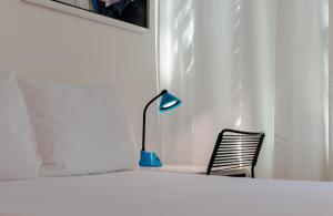 Postel nebo postele na pokoji v ubytování Kubo Hotel