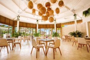 a restaurant with tables and chairs and windows at Secrets Playa Mujeres Golf & Spa Resort - All Inclusive Adults Only in Cancún