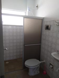 a bathroom with a toilet and a sink at Mar Azul Condomínio in Aracaju +11 photos