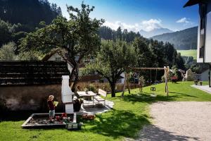 a child standing on a table in a backyard at Willmüllerhof in Perca