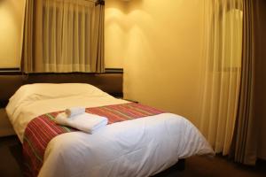 Voodi või voodid majutusasutuse Tampu Hotel toas