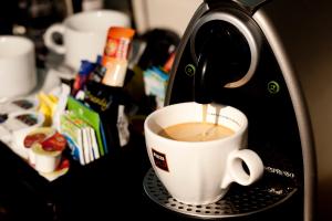 a coffee maker is making a cup of coffee at Park Central Hotel in Bournemouth