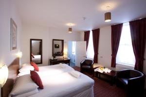 a hotel room with a bed and a desk at Park Central Hotel in Bournemouth