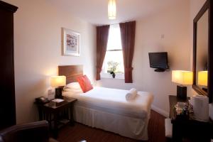 a hotel room with a bed and a window at Park Central Hotel in Bournemouth