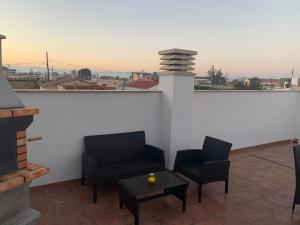 a balcony with two chairs and a table with a view at LA TERRASSETA in Deltebre