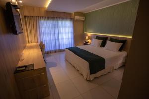 Säng eller sängar i ett rum på Hotel Águas Claras