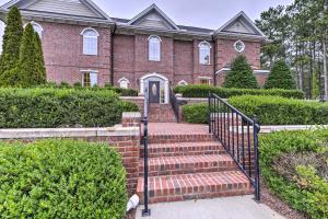 a brick house with a staircase leading to the front door at Resort-Style Condo on Golf Course with Pool Access in Spring Lake