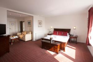 a living room with a bed and a couch at Park Central Hotel in Bournemouth +37 photos