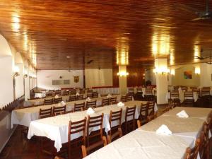 a large banquet hall with tables and chairs at Flat Cavalinho Branco - Apto 509 in Águas de Lindóia