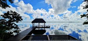 a dock with a gazebo on a body of water at Mi Kasa Tu Kasa Bacalar by Nah Hotels in Bacalar