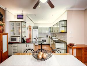 a kitchen with a table with a bowl of fruit on it at Vivienda Turística Rural Mari Carmen in Baeza