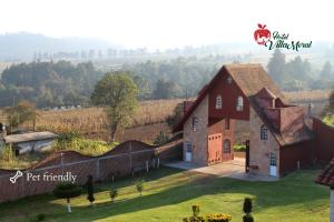a rendering of a large red barn in a field at Hotel Villa Moral in Zacatlán