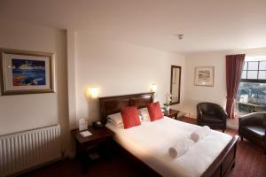 a hotel room with a bed with two pillows at Park Central Hotel in Bournemouth