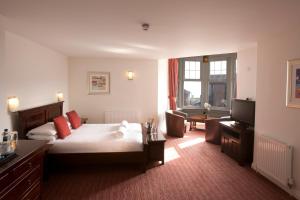 a hotel room with a bed and a television at Park Central Hotel in Bournemouth