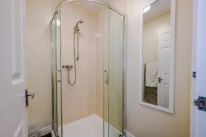a shower with a glass door in a bathroom at Liverpool City Centre - Spacious Duplex - 6 Bedrooms - Sleeps 14 People in Liverpool