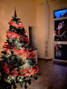 a christmas tree with lights on it in a room at B&B Metropolitan RC in Reggio di Calabria