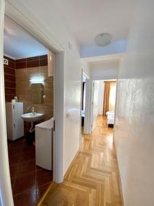 a hallway of a room with a kitchen and a bathroom at Apartments First Line in Petrovac na Moru
