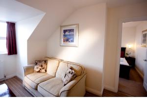 a living room with a couch in a room at Park Central Hotel in Bournemouth