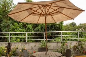 een paraplu op een tafel in een tuin bij CabanaCopa Hostel in Rio de Janeiro
