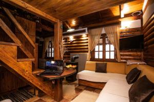 a bedroom with a bed and a laptop on a desk at Rzav, ti i ja. in Arilje