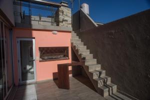 a staircase leading up to a building with a toilet at Amares Apart - Departamentos 1 y 2 in Santa Clara del Mar +2 photos