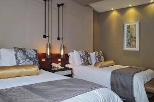 a hotel room with two beds in a room at Alesia - Boutique Hotel & Spa in Aguascalientes