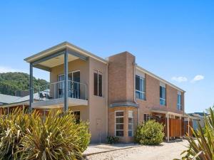 a brick building with a balcony on top of it at 32 Scenic Apollo in Apollo Bay