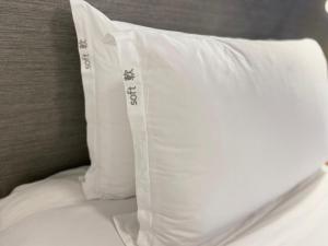 a white pillow sitting on top of a bed at Holiday Inn Express Hong Kong Causeway Bay, an IHG Hotel in Hong Kong