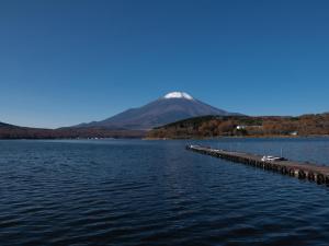 a large body of water with a mountain in the background at Tabist Lakeside in Fujinami Yamanakako in Yamanakako