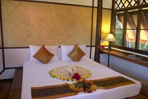 Voodi või voodid majutusasutuse Le Dugong Libong Resort toas