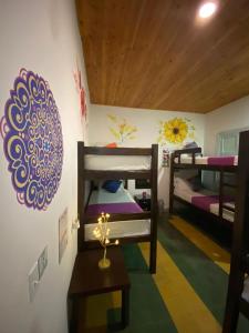 a room with two bunk beds and a table at Hotel boutique stay la 10 in Medellín