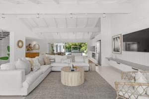 a living room with a white couch and a table at Alkira in Lennox Head