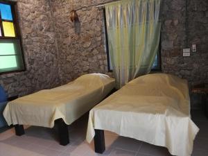 a room with two beds and a window at Farm stay 1000 Chang Valley in Ban Chak Phai