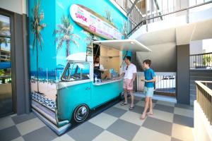 two people ordering food from an ice cream truck at Paradise Resort Gold Coast in Gold Coast