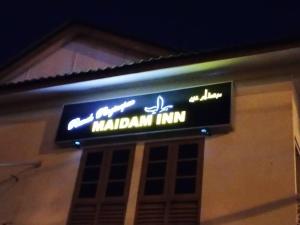 a sign for a marawi inn on the side of a building at MAIDAM Inn in Jertih